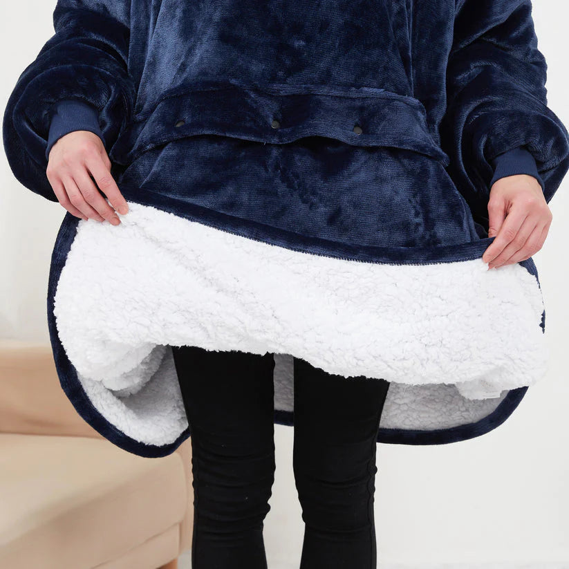 Close-up of the soft black plush fabric on the heated hoodie blanket